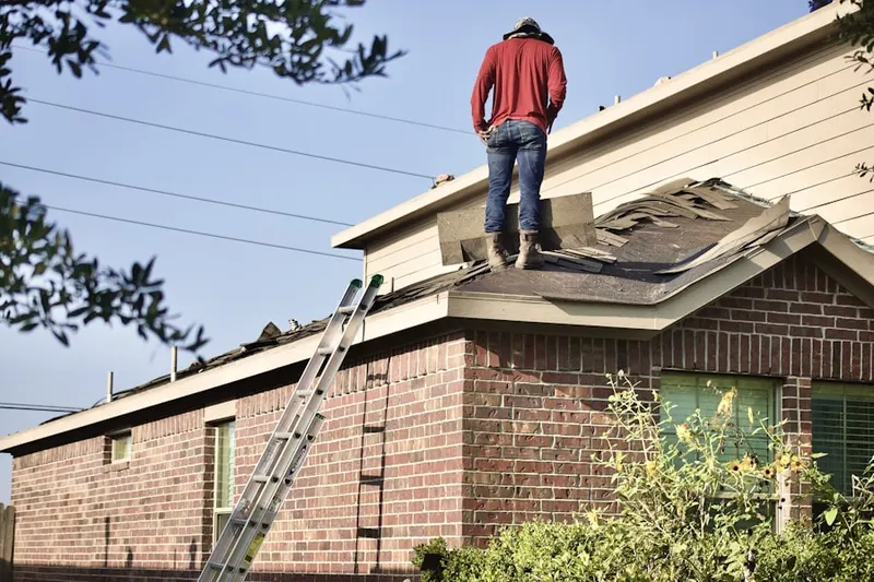 Professional roofer working on a residential roof in Gulf Park Estates